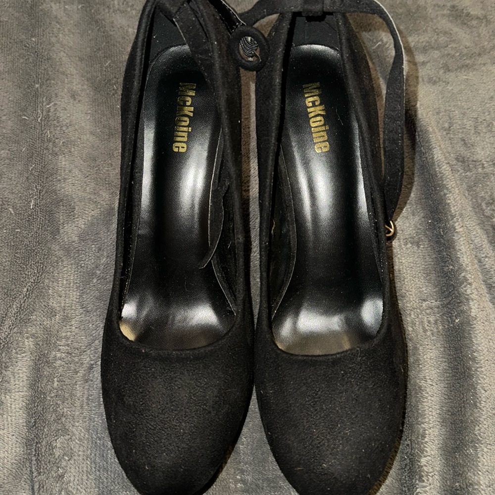 Women’s black suede high heels.